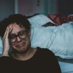 person crying beside bed